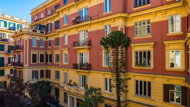 A multi-story building with balconies and windows.