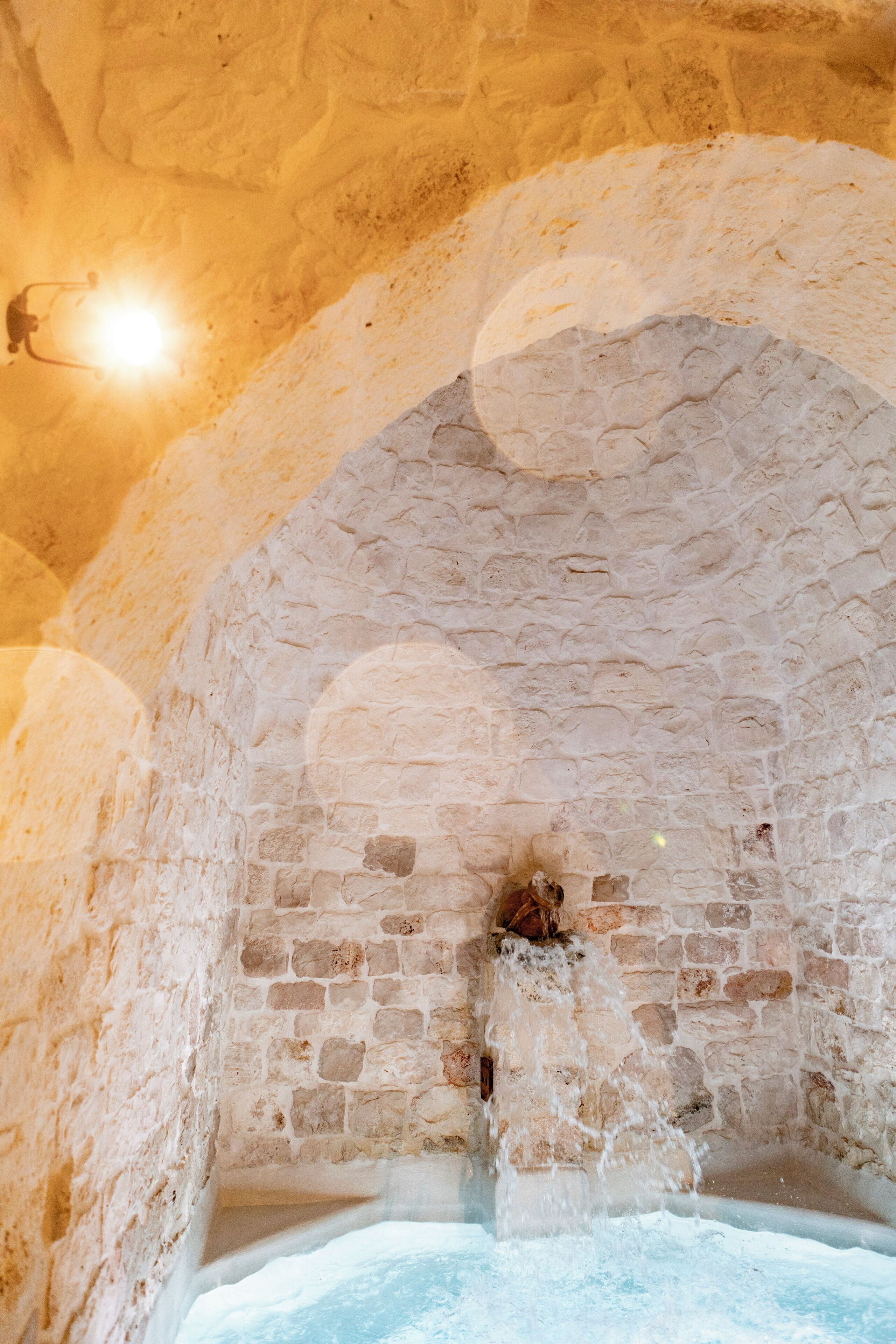 An arched stone ceiling with a small opening at the base.