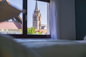 A window view of a church tower with a clear sky. - Charming apartment "Altes Kino" with 2SZ-2BZ and terrace (Baden-Baden)