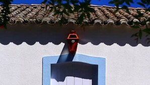 A white door with a blue frame and a small orange mailbox above it. - Wood Oven House II in Azeit o (Setubal)