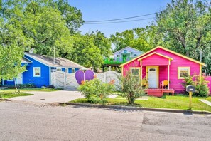 A row of colorful houses with a clear driveway and a mailbox.