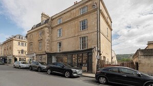 A historic building with multiple stories, large windows, and a prominent entrance.