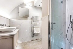 Shower, hair dryer, towels, shampoo