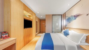 A hotel room with a bed, wooden paneling, a flat-screen TV, a window with blinds, and a wall-mounted artwork. - Guangzhou Hongcheng Hotel  (Guangzhou)