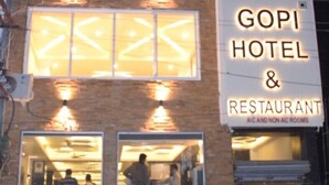 A building with a sign for Gopi Hotel & Restaurant, featuring multiple windows and a visible entrance. - Gopi Hotel And Restaurant (Sagwara)