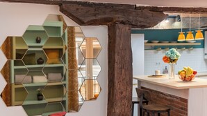 A kitchen with a wooden beam ceiling, a hexagonal mirror, and a fruit bowl on the counter. - ☀️❤️Historic penthouse in the heart of Santander ! ❤️☀️ (Santander)