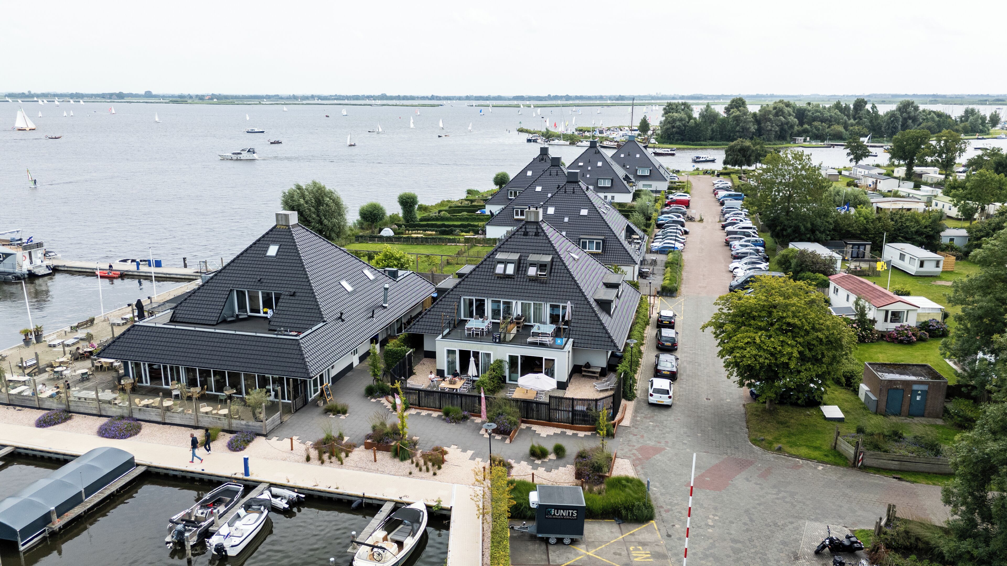 A lakeside property with multiple houses, a marina, and a parking area.
