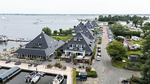 A lakeside property with multiple houses, a marina, and a parking area.