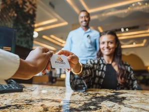 A person holding a business card with 'PYRAMID Hotels & Resorts' logo. - Pyramid Hotels & Resorts  (Bishoftu)