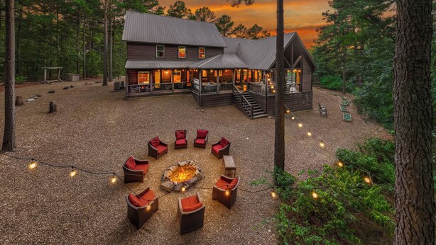 A lodge with a fire pit, outdoor seating, and a deck.