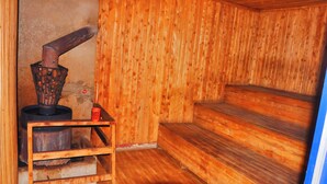 A sauna room with wooden walls and benches. - Dream Jet Suites (Entebbe)