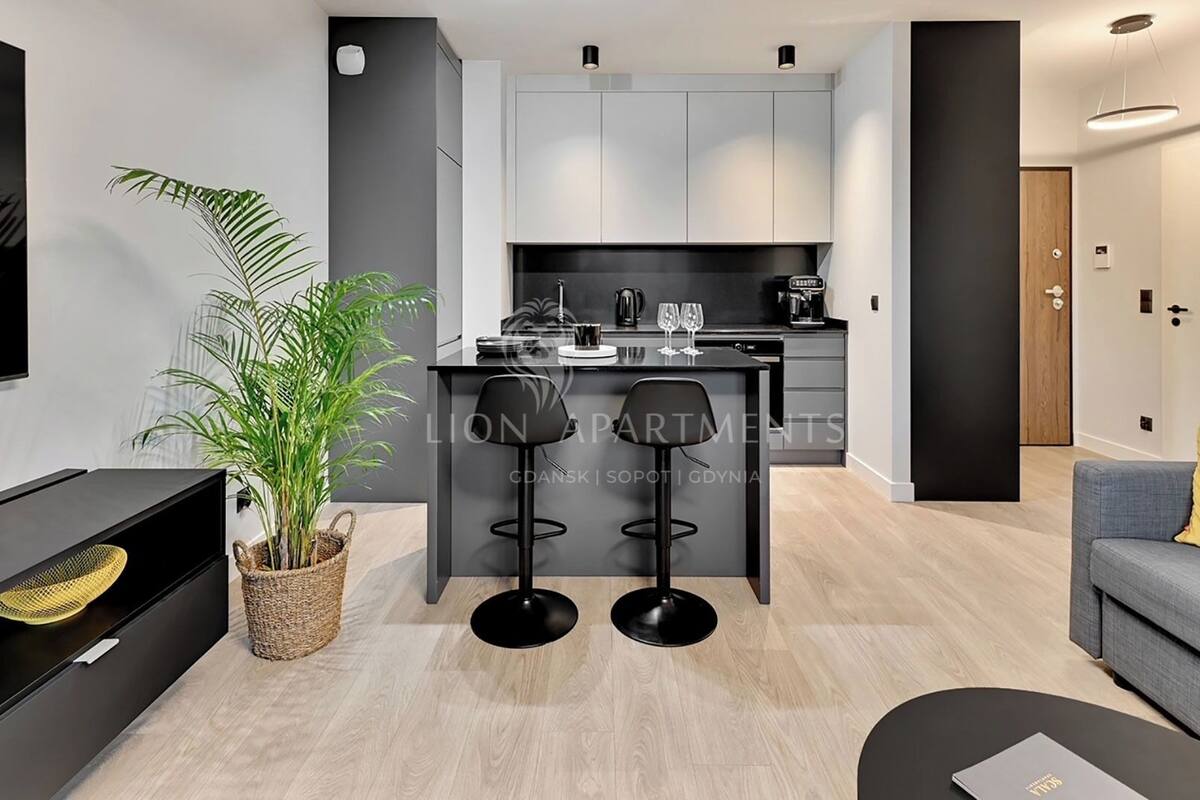 A modern apartment with a kitchen, dining area, and living space.