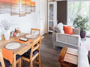 A dining area with a wooden table, chairs, and a buffet. - 1 bedroom accommodation in Bideford (Bideford)