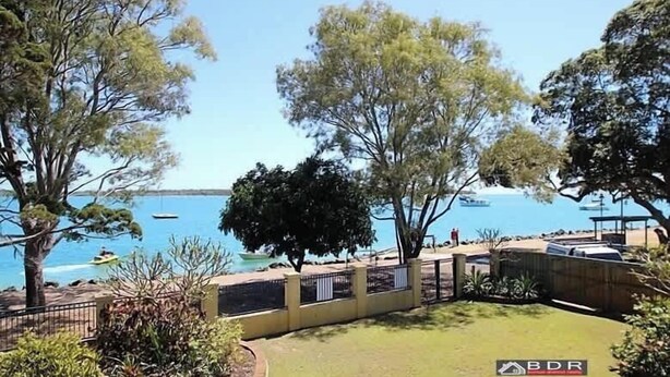 A coastal property with a fenced yard, a view of the sea, and a boat dock. - The Sandcastle at Burrum Heads (Burrum Heads)