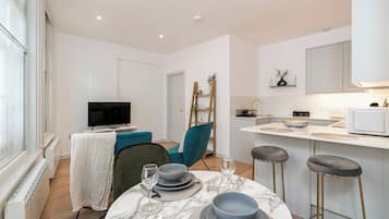 Standard Apartment | Living area | 30-inch LED TV with cable channels