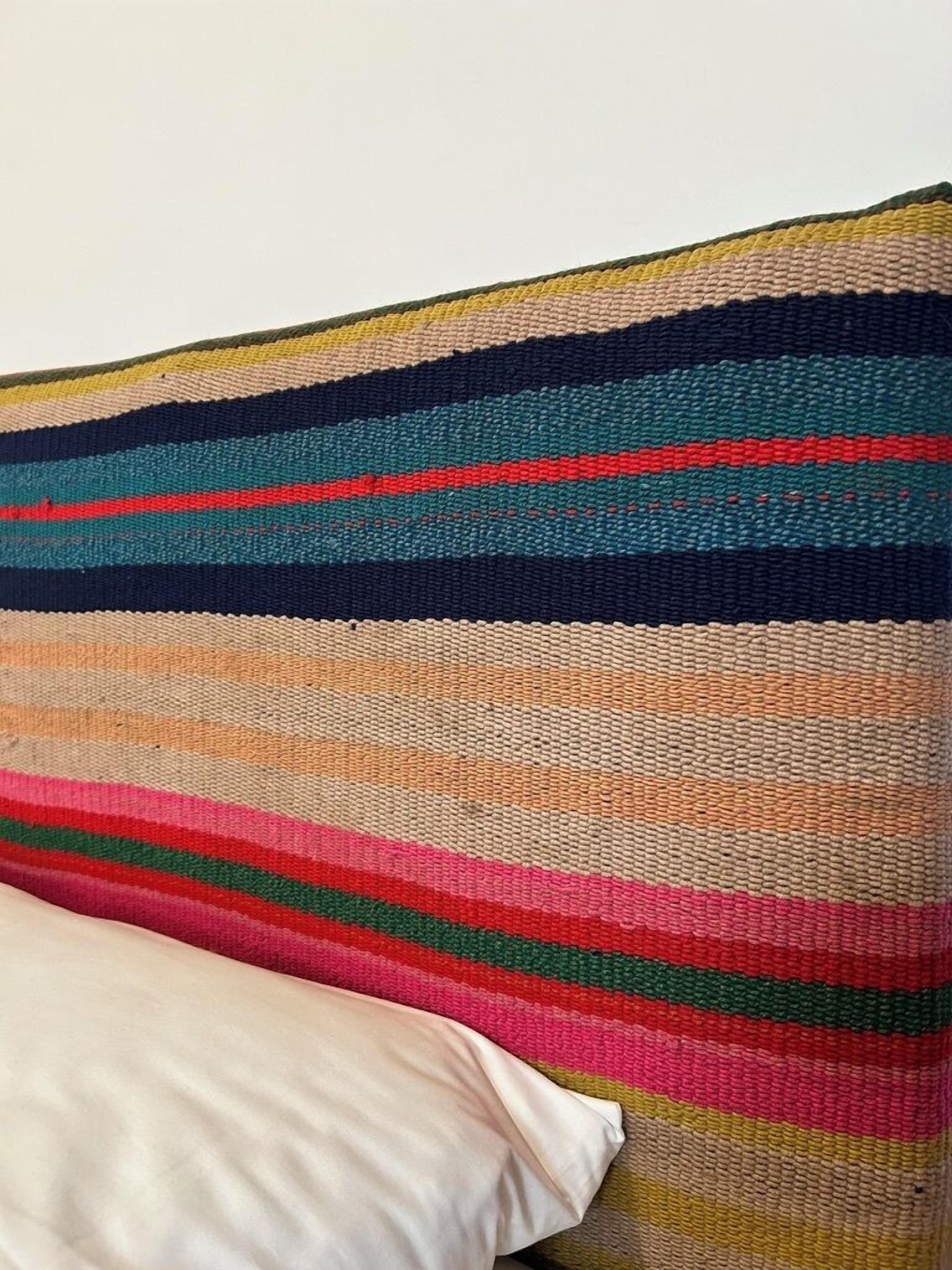 A striped pillow with multiple colors.