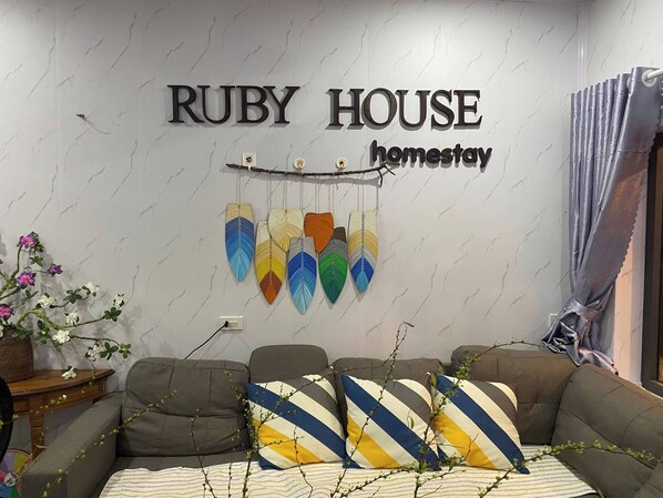 Relax in the stylish living room with a large sofa, decorative ornaments, and a cozy side table.
