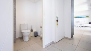 A modern bathroom with a toilet, bidet, and trash bin. - Valras'Loc Archipel Capri – Sea View Escape (Valras-Plage)