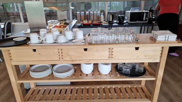 A buffet setup with various food items, utensils, and glassware. - Hunavellir Guesthouse (Blönduós)
