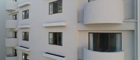 A modern building with multiple balconies and windows.