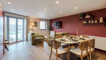 Superior Apartment | Living area | 38-inch Smart TV with cable channels