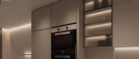 A modern kitchen with built-in appliances, a round dining table, and a minimalist design.