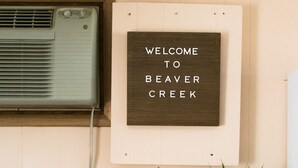 A kitchen with a microwave, toaster, and a welcome sign. - Cabin #2 at Beaver Creek (Strasburg)