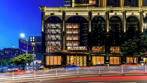 A hotel with a grand entrance, large arched windows, and a well-lit facade. - Imperial Dragon Bay Purejoy Hotel (Nanning)