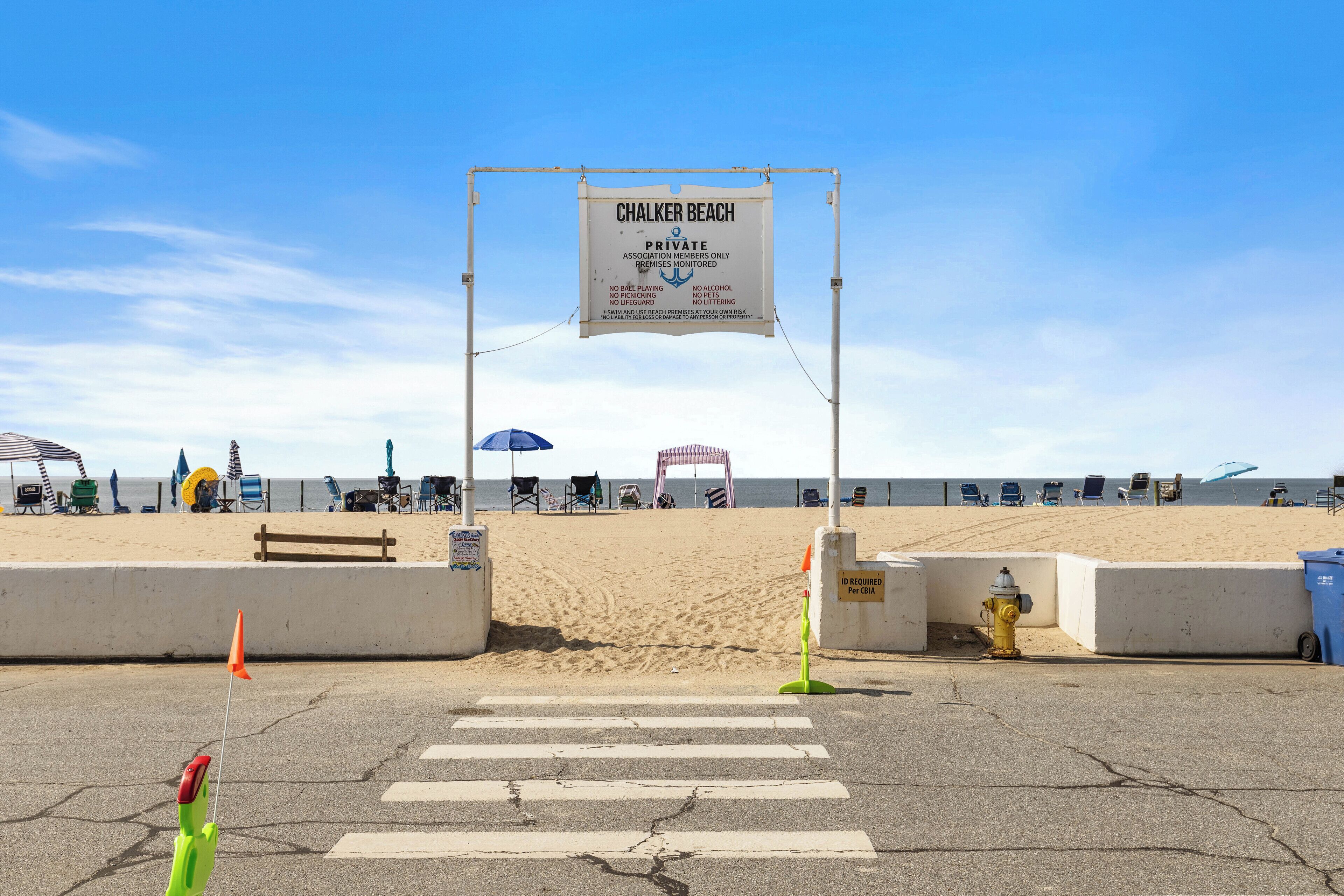 A beach entrance sign for Chalker Beach, indicating it is private and members only.