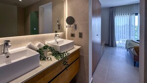 A modern bathroom with two sinks, a mirror, and a potted plant. - Exclusive Penthouse With Picuzzi Steps From Beach (Punta Cana)