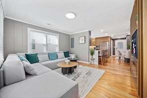Relax in this stylish living room with a comfortable sofa, coffee table, and flat-screen TV.