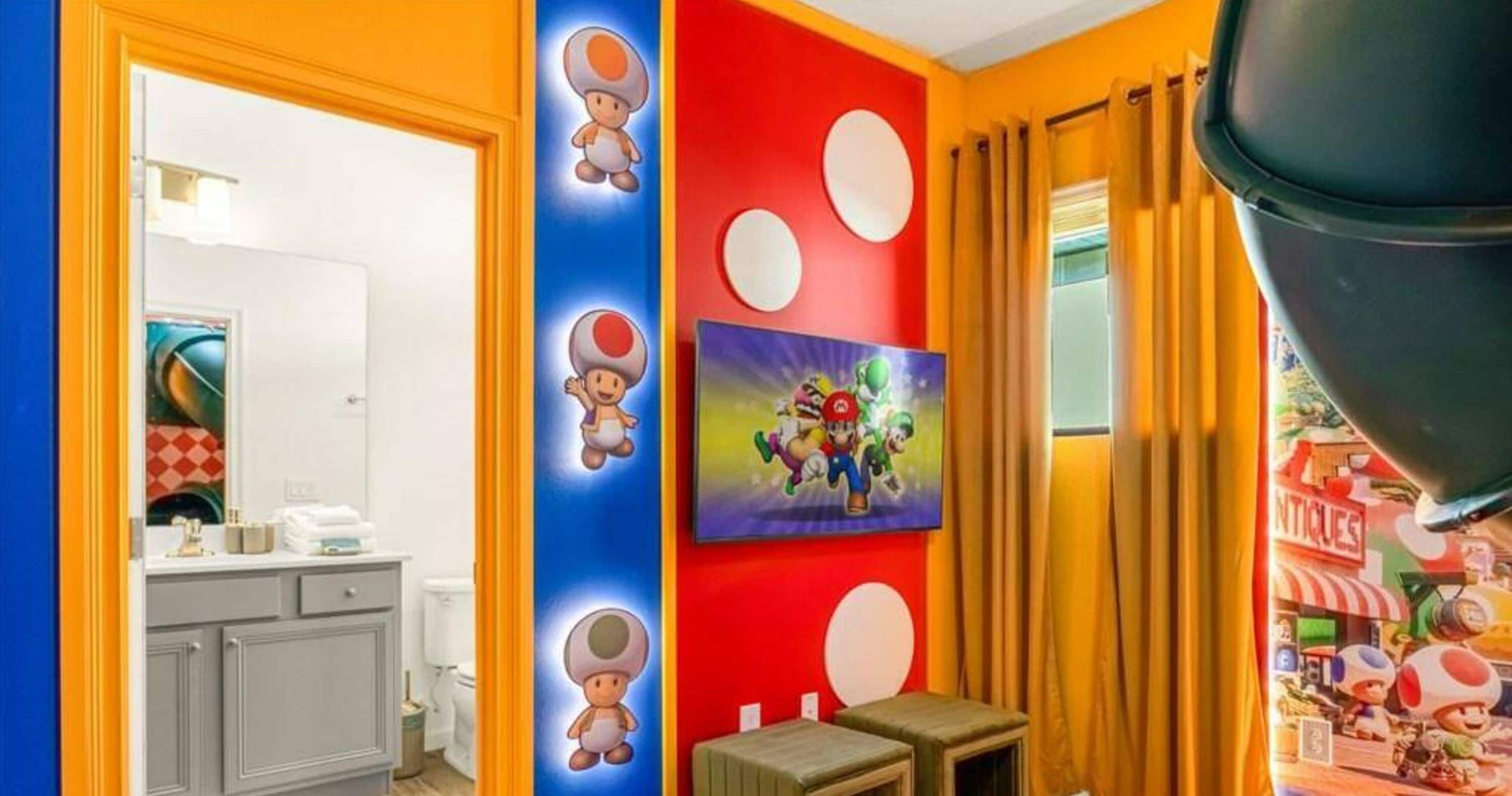 A room with a red and blue wall, a painting of Mario and Luigi, and a Nintendo 64 console.