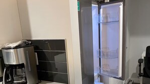 A compact kitchenette with a coffee maker, a refrigerator with a water dispenser, and a small countertop. - Luxurious 2 Bdrm Suite ~ North Edmonton (3min to Anthony Henday/Manning Dr) (Edmonton)