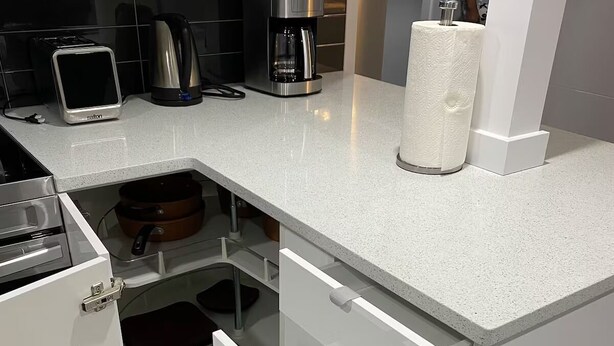 A modern kitchen with a built-in toaster, coffee maker, and a paper towel dispenser. - Luxurious 2 Bdrm Suite ~ North Edmonton (3min to Anthony Henday/Manning Dr) (Edmonton)