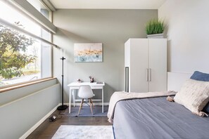 A bedroom with a bed, a desk, and a wardrobe. - The Imagination House! (Seattle)