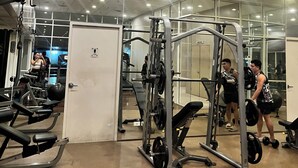 A gym with various exercise equipment, including weight machines and free weights.