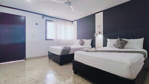 A hotel room with two beds, a ceiling fan, a window with curtains, and a tiled floor. - Hotel Don Luis  (Valladolid)
