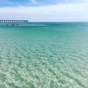 A clear view of a pier extending into the ocean with calm waters. - Beachview 102 - Flaming Sunrise (Navarre)