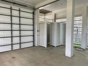 A garage with a closed white garage door and a concrete floor.