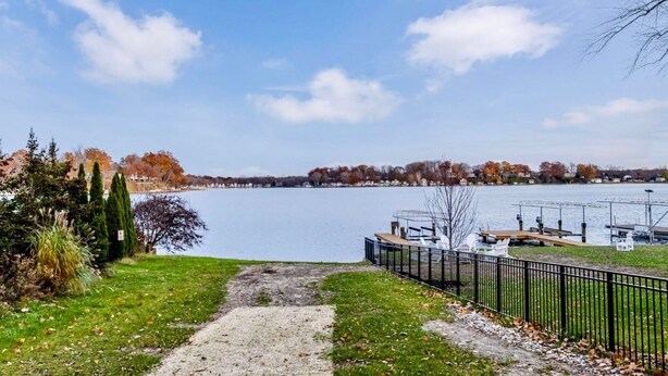 A lakeside park with a walking path, dock, and boats. - Charming 2-bedroom house in serene Coloma with AC, WiFi (Coloma)