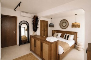A bedroom with a wooden bed, a large mirror, a wardrobe, and a hanging light fixture. - Roof Rooms Fethiye (Fethiye)