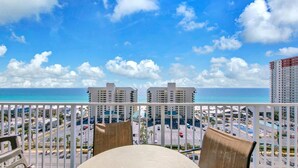 A balcony with a view of the ocean and a parking lot. - Laketown Wharf 1116 (Panama City Beach)