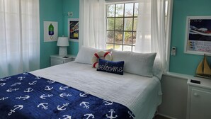 A bedroom with a bed, a window, a ceiling fan, and a wall-mounted air conditioner. - Charming 2 BR cottage in Great Guana Cay short walk to beach,  AC WiFi Generator (Great Guana Cay)