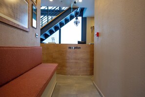 Welcome to the reception area, featuring a spacious reception desk and a staircase leading to an upper level.
