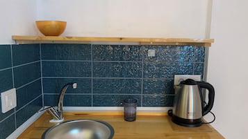 Twin Room, Garden View | Private kitchen | Mini-fridge, highchair