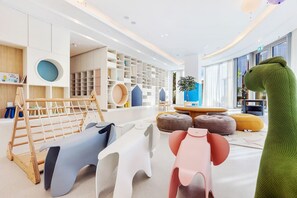 Kids can play and relax in this vibrant play area with a variety of structures and seating options.
