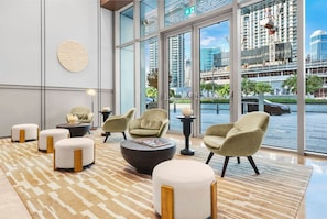 Relax in our spacious lobby with a mix of sofas and armchairs, surrounded by floor-to-ceiling windows offering views of the city.