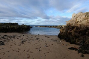 Escape to a serene coastal haven with a tranquil beach and scenic views.