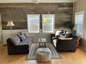 A living room with two sofas, a coffee table, and a rug.