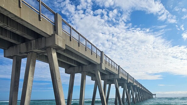 A pier extending into the ocean with a clear sky above. - Charming 2-bedroom suite in soothing Navarre with AC, WiFi (Navarre)